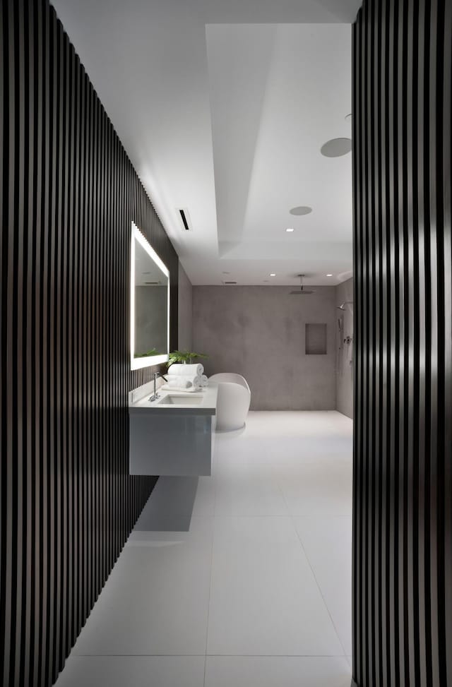 bathroom featuring vanity, tile patterned flooring, and a shower