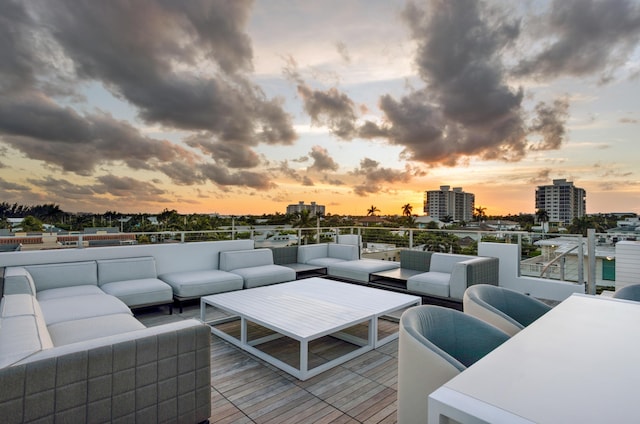 deck at dusk with an outdoor living space