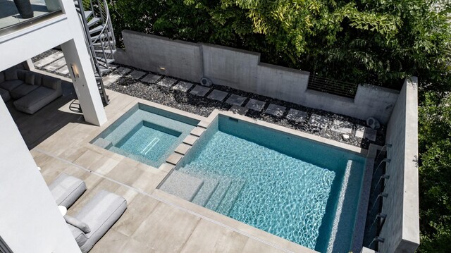 view of pool featuring an in ground hot tub and a patio area