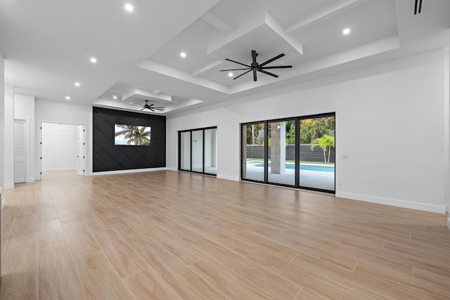 unfurnished living room with ceiling fan, light wood-type flooring, and coffered ceiling