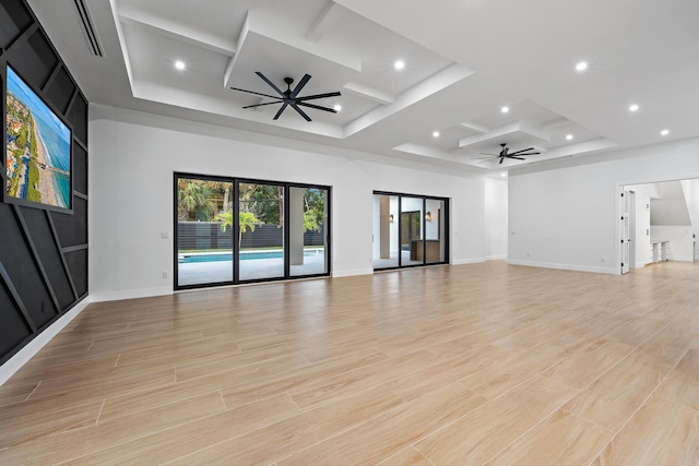 unfurnished living room featuring light hardwood / wood-style floors, ceiling fan, and coffered ceiling