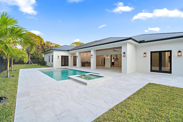 back of house with ceiling fan, a yard, french doors, a swimming pool with hot tub, and a patio