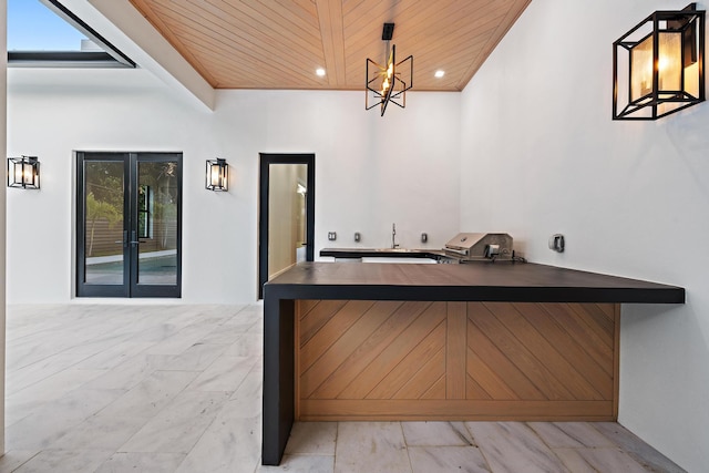 bar featuring hanging light fixtures and wood ceiling