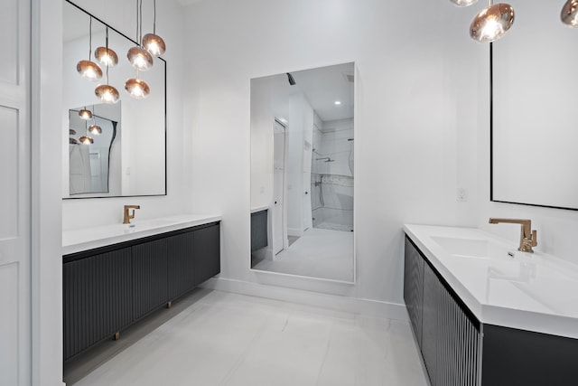 bathroom with tile patterned floors, vanity, tiled shower, and a chandelier