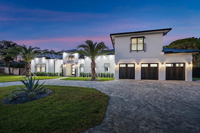 view of front of home featuring a lawn and a garage