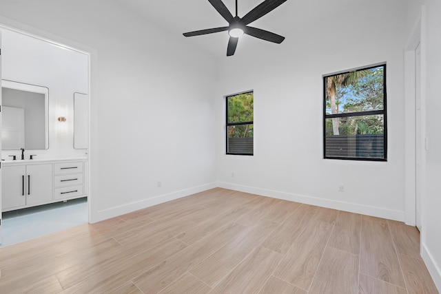 unfurnished bedroom with ceiling fan and light wood-type flooring