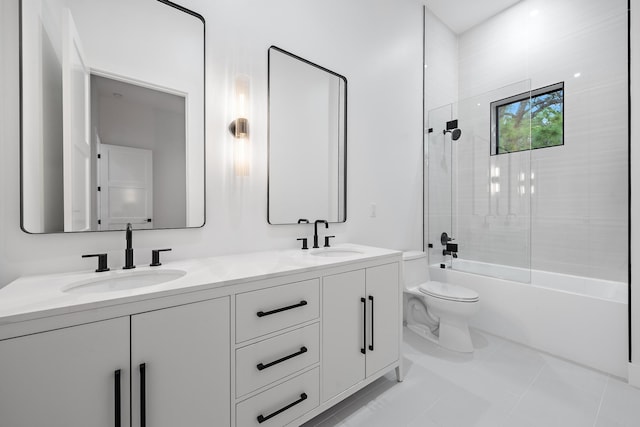 full bathroom featuring tile patterned flooring, vanity, toilet, and tiled shower / bath