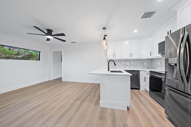 kitchen featuring white cabinetry, sink, light wood-type flooring, and appliances with stainless steel finishes