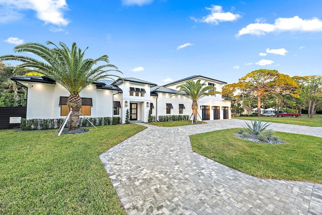 view of front facade featuring a front yard and a garage