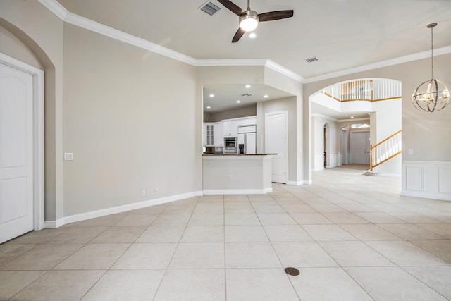 unfurnished living room with light tile patterned flooring, ornamental molding, and ceiling fan with notable chandelier