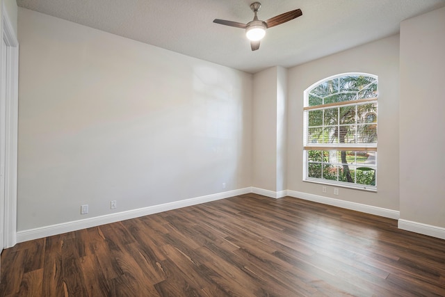 spare room with dark wood-type flooring, ceiling fan, and a textured ceiling