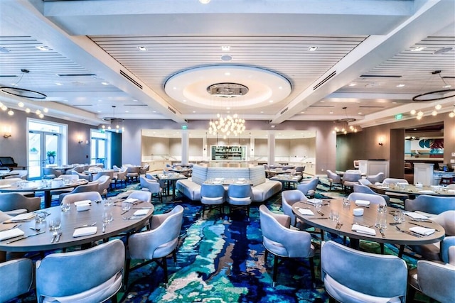 dining space featuring beam ceiling and a notable chandelier