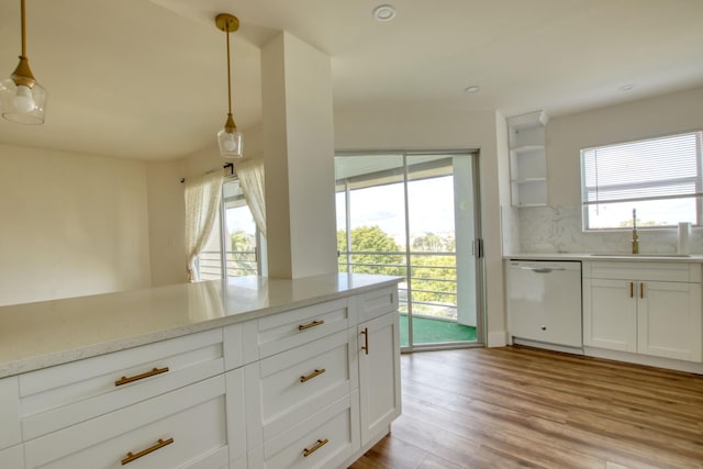 kitchen with light hardwood / wood-style flooring, sink, a wealth of natural light, and dishwasher