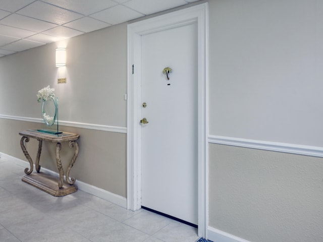 interior space featuring a drop ceiling and light tile patterned flooring