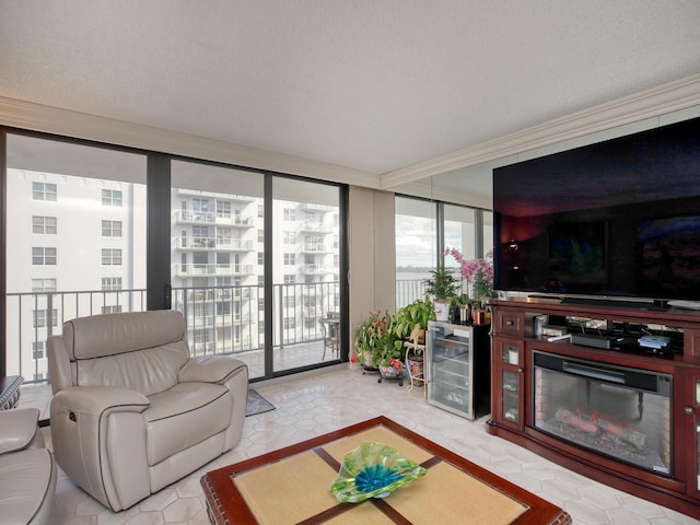 living room featuring wine cooler, expansive windows, and a textured ceiling