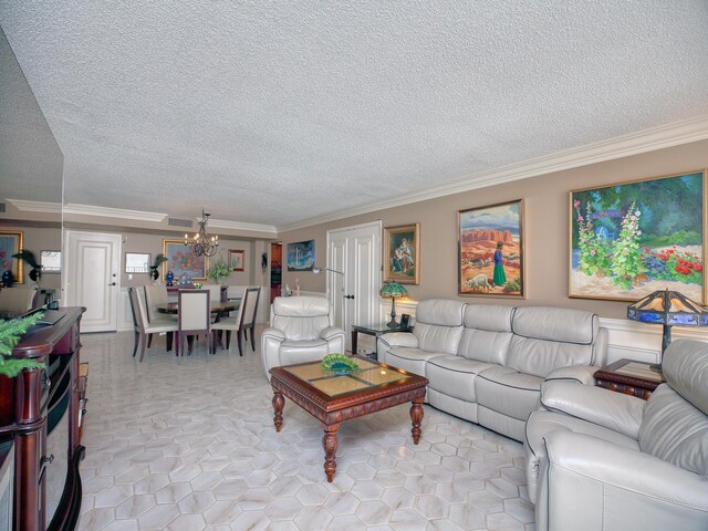 living room featuring light tile patterned flooring, a textured ceiling, a chandelier, and ornamental molding