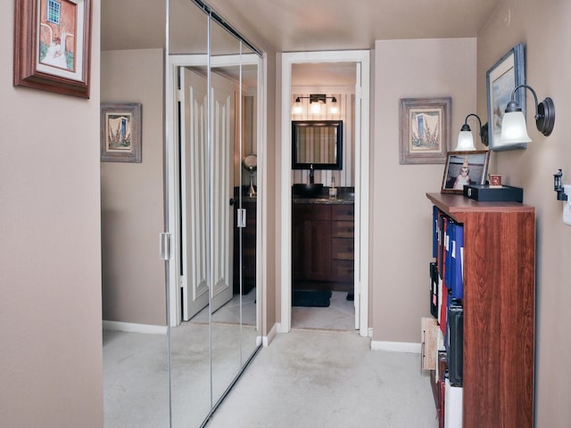 hallway featuring light carpet