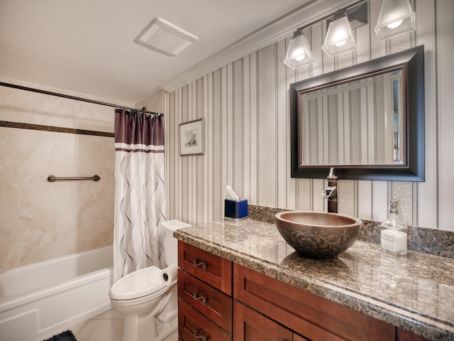 full bathroom featuring shower / bath combo with shower curtain, tile patterned floors, toilet, and vanity