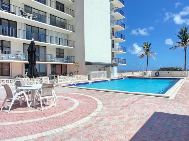 view of swimming pool with a patio