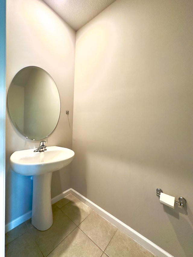 bathroom with tile patterned floors and a textured ceiling