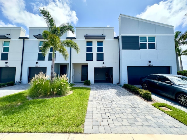 view of front facade with a garage and a front lawn