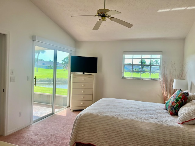 bedroom with ceiling fan, lofted ceiling, access to outside, and light carpet