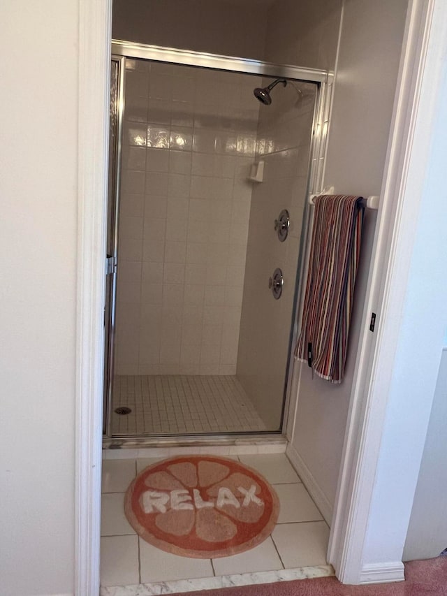 bathroom featuring a shower with door