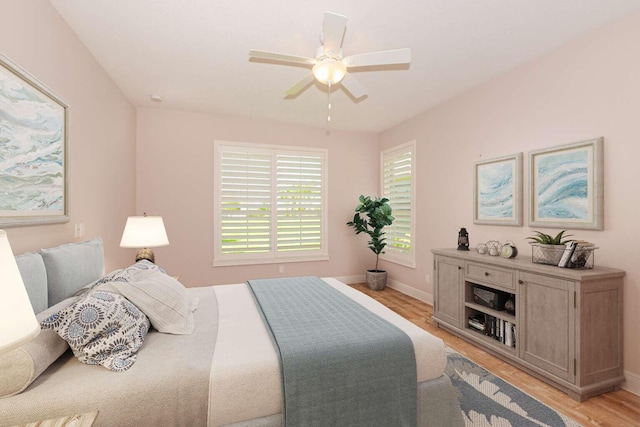 bedroom with ceiling fan and light hardwood / wood-style flooring