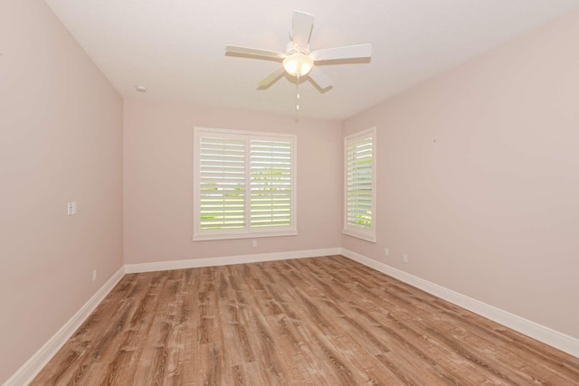 spare room featuring light hardwood / wood-style flooring and ceiling fan