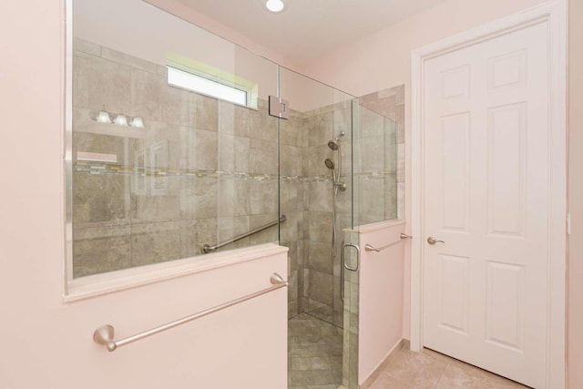 bathroom featuring a shower with shower door and tile patterned floors