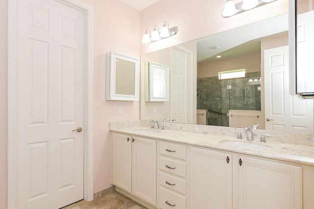 bathroom with double vanity, a stall shower, and a sink