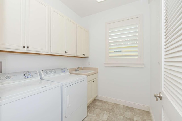 clothes washing area with sink, cabinets, washer and clothes dryer, and light tile patterned floors