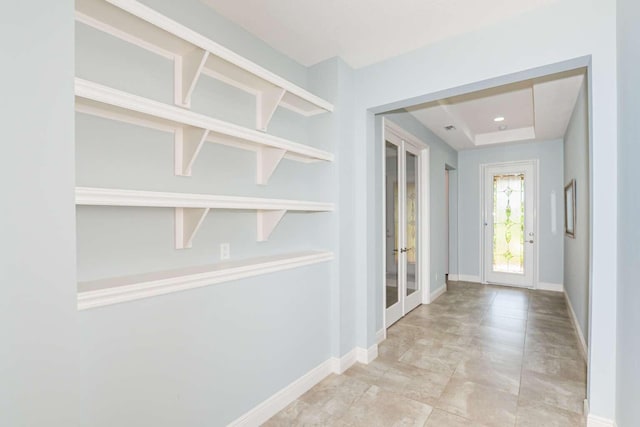 doorway to outside with baseboards