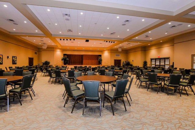 dining area featuring beamed ceiling, light carpet, and coffered ceiling