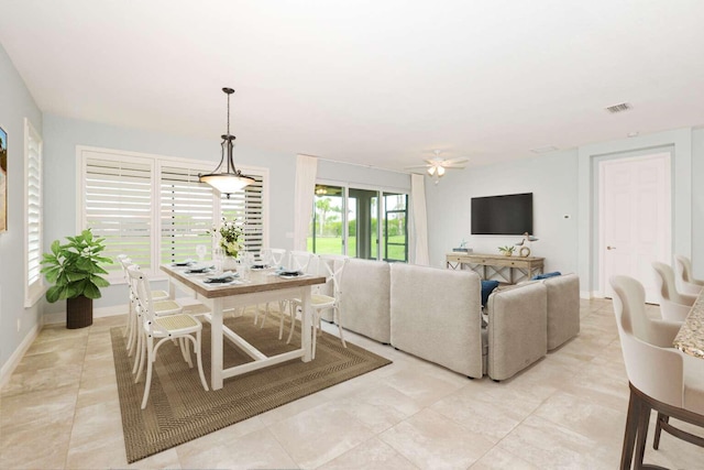 dining room with a ceiling fan, visible vents, and baseboards