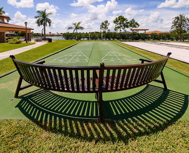 view of community featuring a yard and shuffleboard