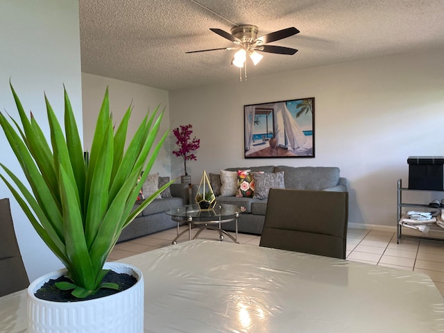 tiled living room with ceiling fan and a textured ceiling