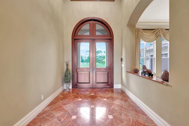 entrance foyer featuring french doors and plenty of natural light