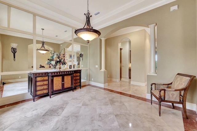 bar featuring hanging light fixtures, ornate columns, and crown molding