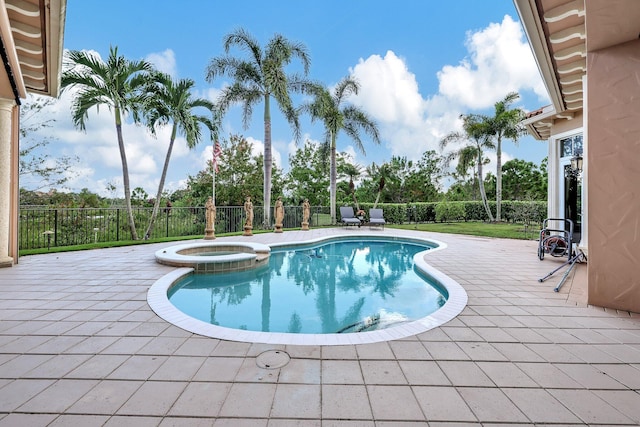 view of pool with a patio area and an in ground hot tub