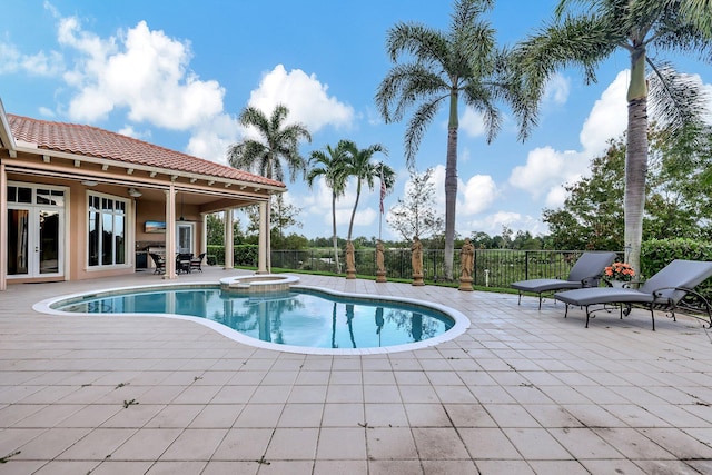 view of pool with a patio and an in ground hot tub