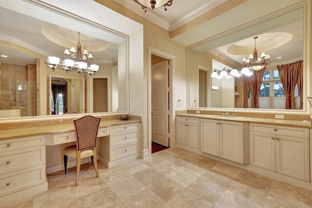 bathroom featuring ornamental molding, vanity, a chandelier, and a tray ceiling