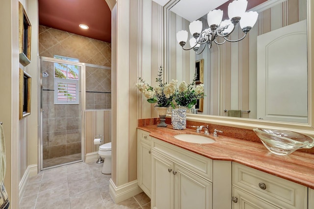 bathroom featuring vanity, tile patterned floors, toilet, and an enclosed shower