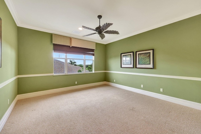 carpeted spare room with ornamental molding and ceiling fan