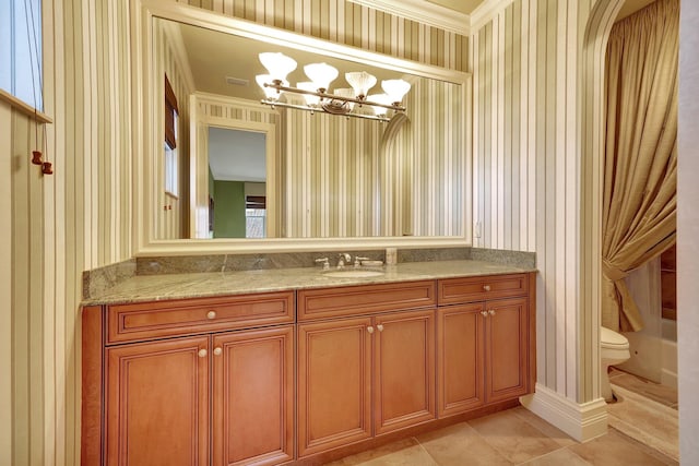 bathroom featuring vanity, tile patterned floors, toilet, and crown molding