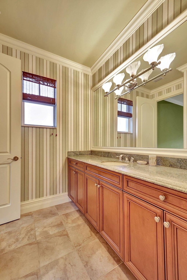 bathroom with ornamental molding, a wealth of natural light, and vanity