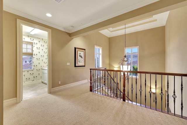 corridor featuring a notable chandelier, light carpet, and ornamental molding