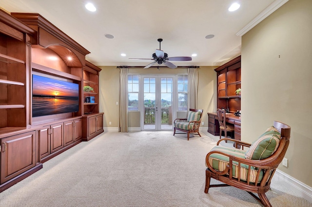 living area featuring ceiling fan, crown molding, light carpet, and french doors