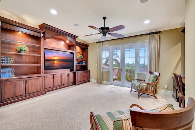 living room featuring ceiling fan, french doors, light colored carpet, and ornamental molding