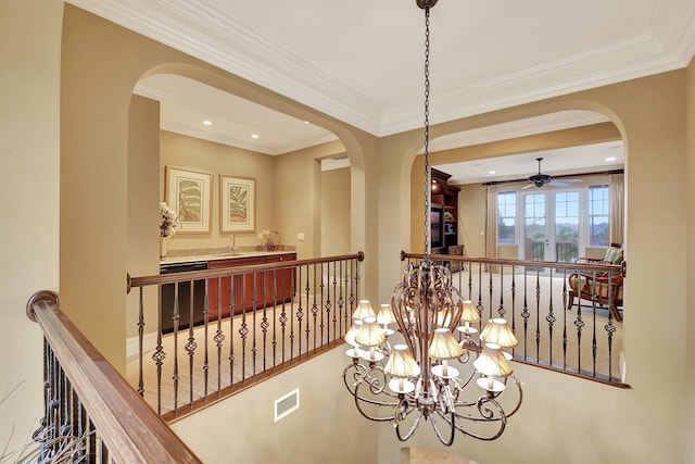 hall featuring a notable chandelier and crown molding